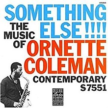 The first recording album cover titled "Something Else!" by Ornette Coleman with his black and white cutout photograph of his picture playing the alto saxophone on lower left corner facing right with the title "SOMETHING ELSE! THE MUSIC OF ORNETTE COLEMAN" written in all capital letters and splashed across the front of the album cover.