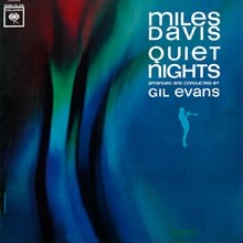 Album cover for Miles Davis's album "Quiet Nights" with dark blue paint swaths with some green and red on the upper left hand side possibly presenting a flower.