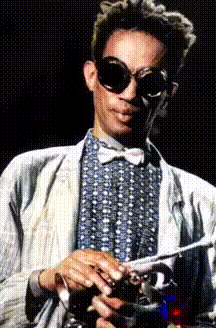 Don Cherry wearing googles and holding his trumpet at his waist in both hands.  The photograph has been colorized and put into 3D with AI software.