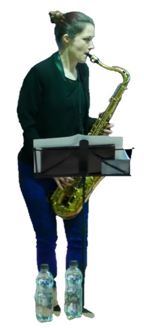 A detail of a color photograph of Trish Clowes playing her tenor saxophone in profile turned to viewer's right.