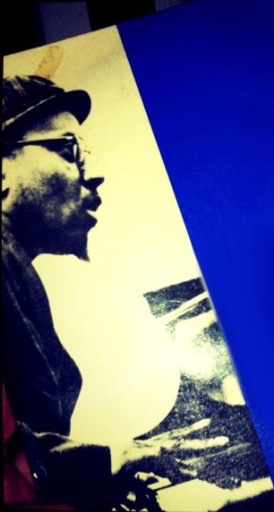 An enhanced graphic with Thelonious Monk having a pointed goatee and wearing glasses in right profile sitting at a piano.