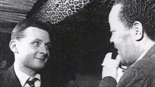 A  black and white photograph of a 20s Stan Getz looking excitedly with bug eyes at Lester Young.