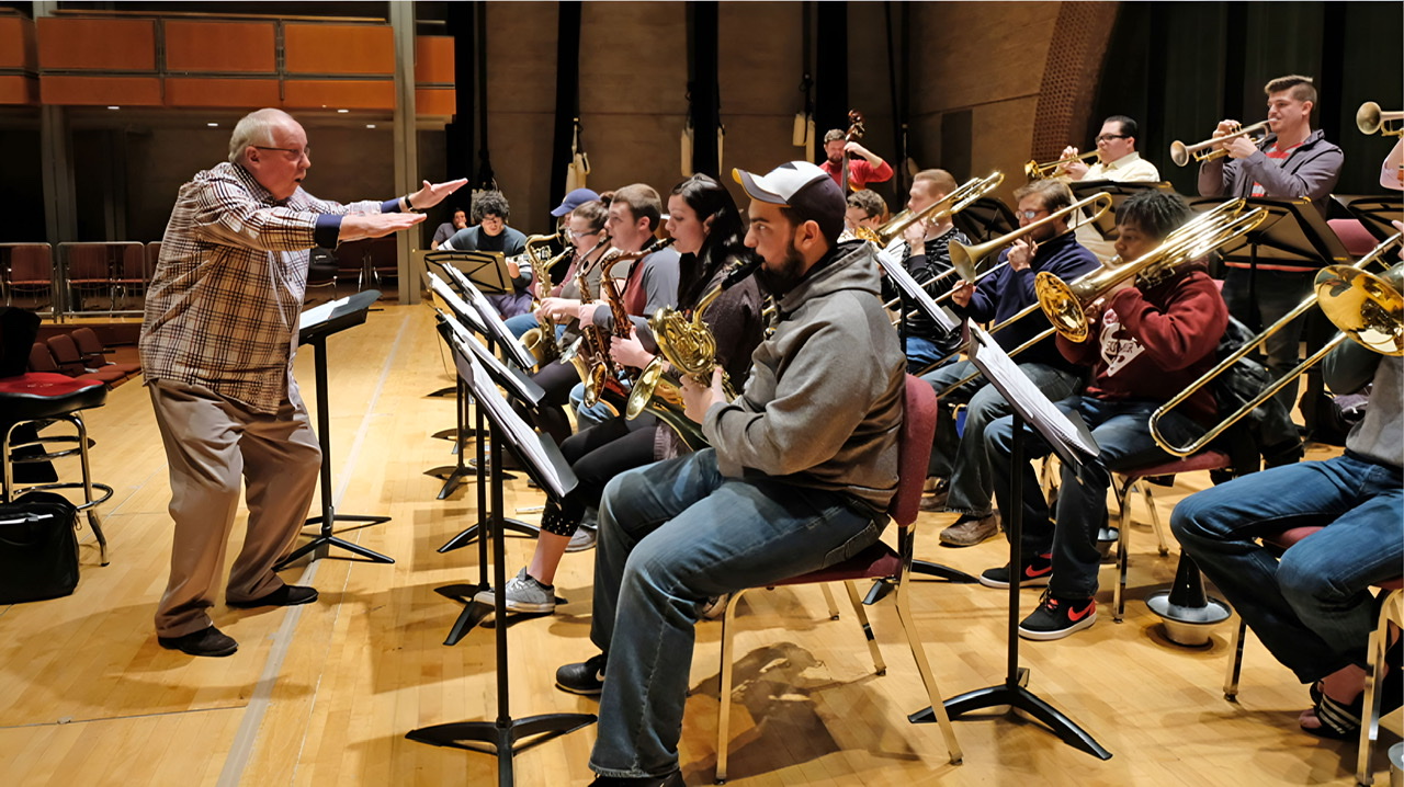 An enhanced color photograph of Jim Widner on left conducting the University of Missouri–St. Louis jazz band.