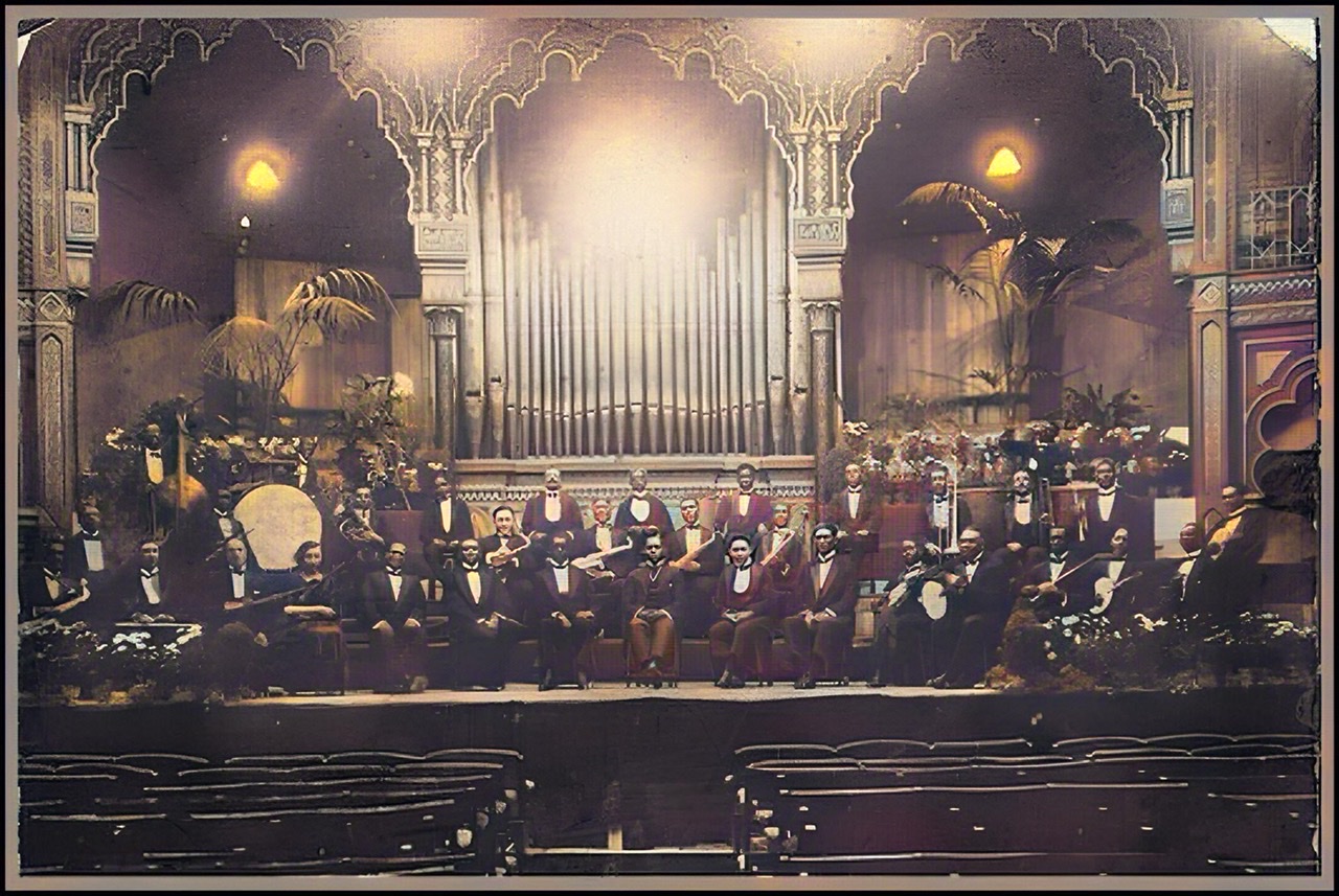 A colorized and extra enhanced old black and white photograph of the Southern Syndicated Orchestra in London, England around 1920.