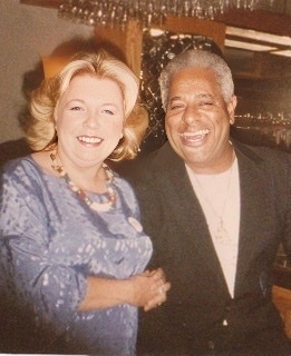 A color photograph of Carol Sloane standing to the left of a smiling Dizzy Gillespie.