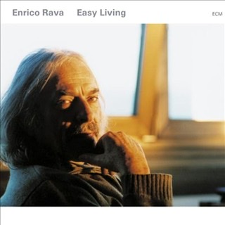 Enrico Rava's album cover for "Easy Living" with a closeup of his head turned to facing camera with right hand touching under his chin.