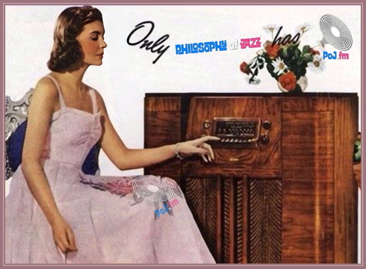 A woman in a 1950s style full length house dress listening to a large brown wooden furniture radio.