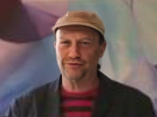 An enhanced color headshot of Stuart A. Kallen wearing a soft cap.