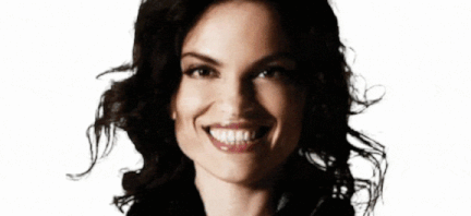 Roberta Gambarini headshot .gif looking straight ahead with big smile and hair moving back and forth.