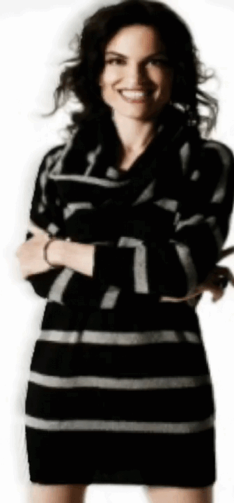 A color photograph of a full body shot of Roberta Gambarini in a black dress facing frontwards with a big smile.