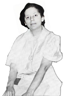 Bertha Gonsoulin wearing a white dress and a plain expression on her face facing the camera.