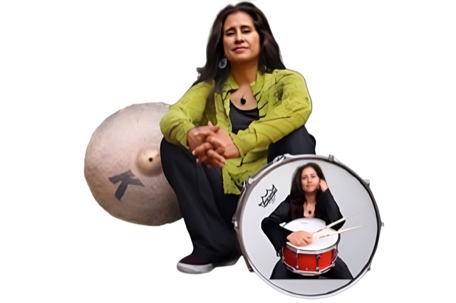 A color photograph of Sylvia Cuenca playing her drums.