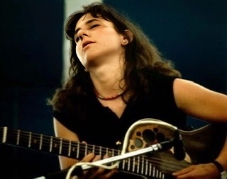 Emily Remler with her head leaning back with her eyes closed playing her guitar.