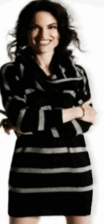 A color photograph of a full body shot of Roberta Gambarini in a black dress facing frontwards with a big smile.