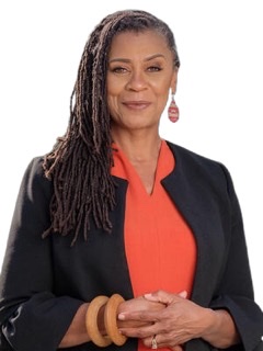 A color cutout of Lenora Zenzalai Helm with an orange blouse under a black jacket with her hair in braids hanging  down all on the right  side of her head (viewers left).